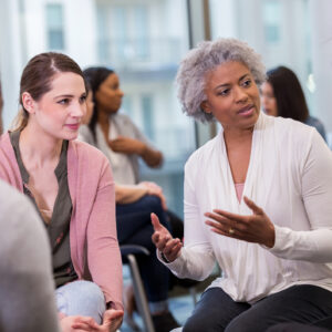 During the breakout session at the conference, a mature woman share insights she has gained in the workplace.